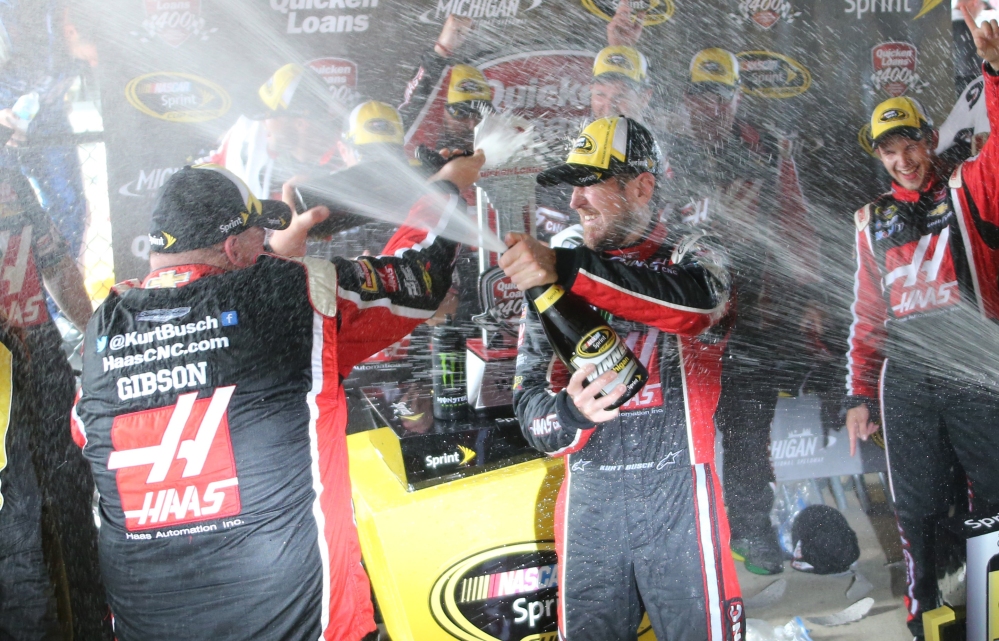Kurt Busch celebrates with teammates after winning the NASCAR Sprint Cup series race Sunday at Michigan International Speedway in Brooklyn, Mich.