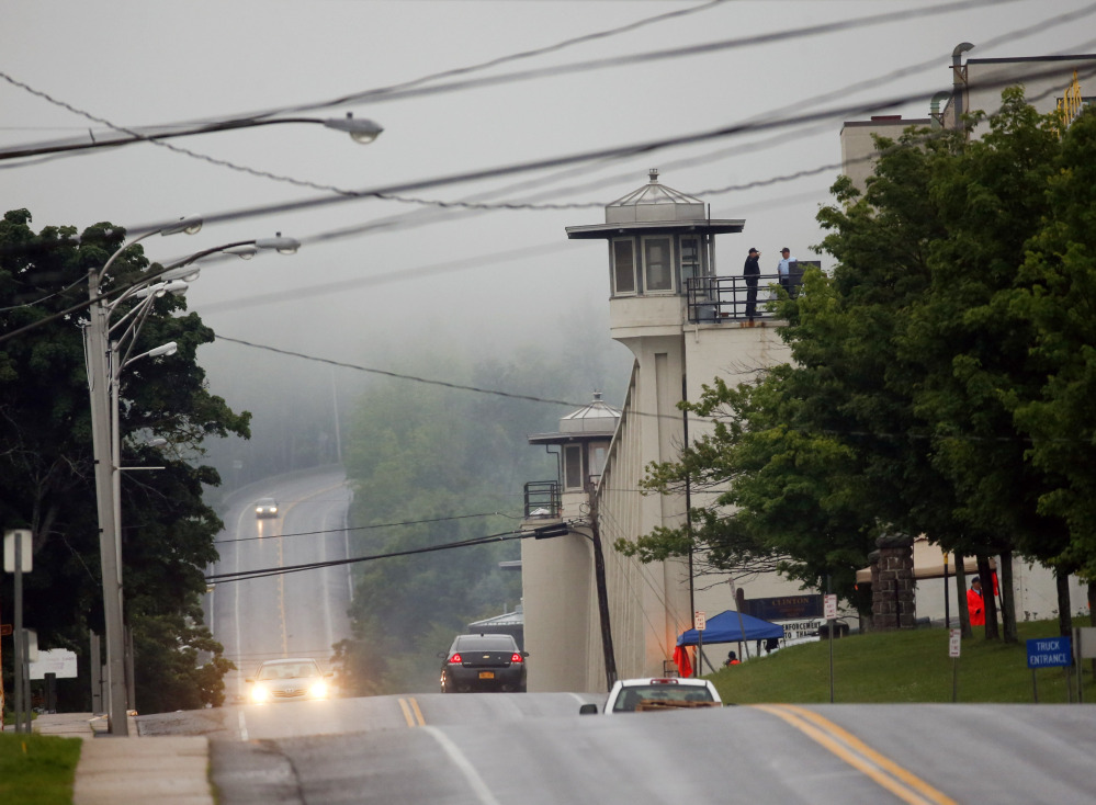 Vehicles drive past Clinton Correctional Facility on Monday, in Dannemora, N.Y.