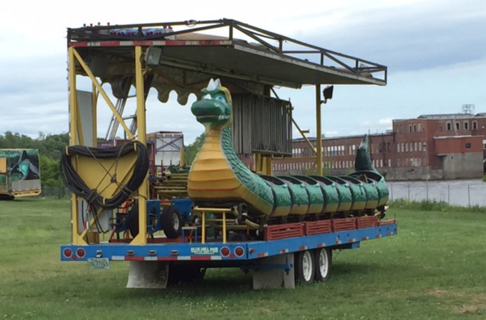The Dragon Wagon ride, an attraction of Smokey’s Greater Shows, sits disassembled and packed up Monday at Head of Falls in Waterville. Three children were hurt Friday night when cars on the ride became uncoupled. The ride was closed down pending an investigation.