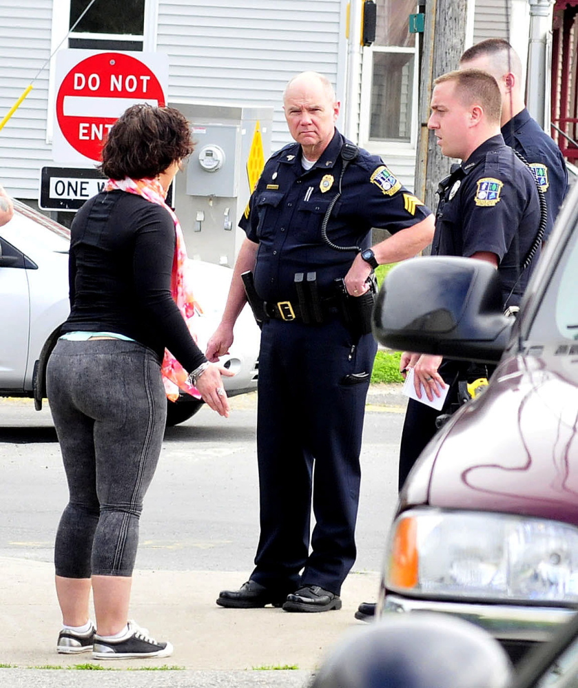 Waterville police talk to Codi Parker, who was later arrested and charged with domestic assault after a confrontation with a former boyfriend on Spring and Elm streets in Waterville on Monday. Parker screamed rape allegations to a growing crowd and allegedly hit the man before police calmed her down.