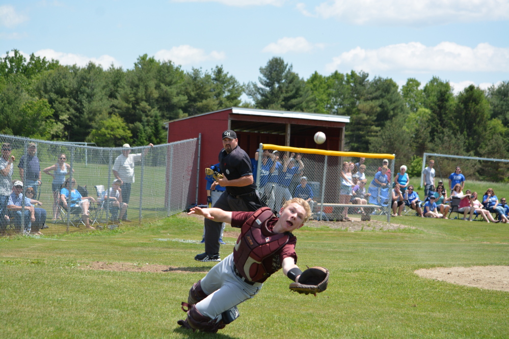 Richmond catcher Brendan Emmons makes an attempt to catch a foul pop-up. The Bobcats will play Searsport for the Western D title today at St. Joseph’s College in Standish.