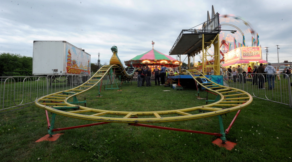 Inspectors from the Office of the State Fire Marshal investigate a ride malfunction at the Smokey’s Greater Show carnival at Head of Falls in Waterville on Friday.