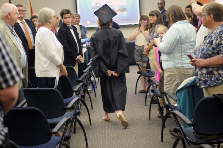 Shaynah-Cherokeigh Raylene Seames, of Bethel, walks on Tuesday into the graduation ceremony for Maine Connections Academy, the state’s first virtual public charter school, in Augusta.