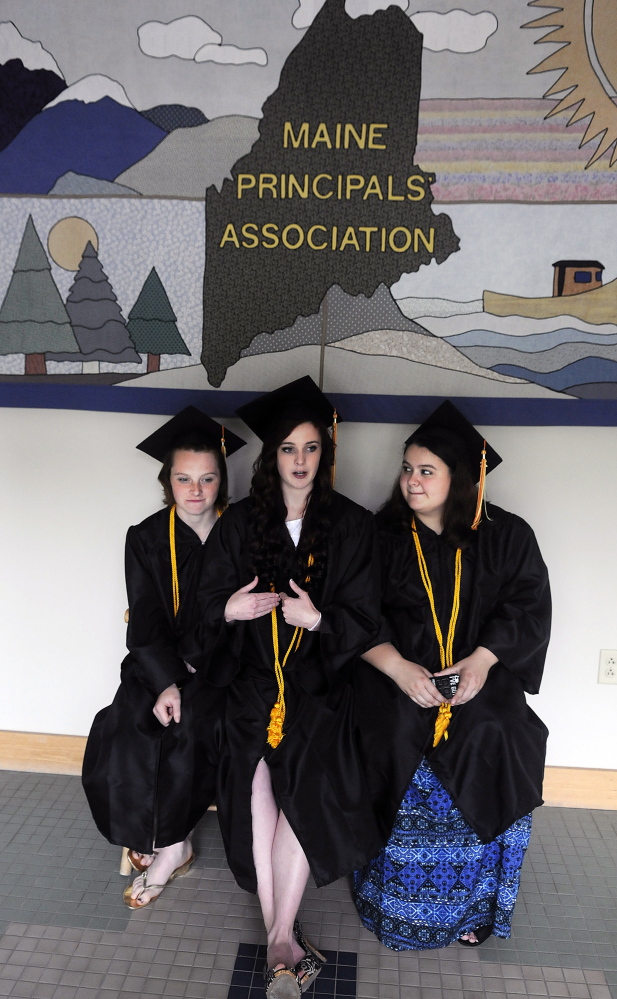 Shaynah-Cherokeigh Raylene Seames, left, of Bethel, Serena Billie-Jo Gorham, of Lyman, and Maddy Dexter, of Portland, wait Tuesday for friends to arrive at their graduation from Maine Connections Academy, the state’s first virtual public charter school, in Augusta. Four students attended the ceremony for graduates of the publicly funded school that is operated by the for-profit firm Connections Academy, the Baltimore-based subsidiary of education publishing giant Pearson PLC.
