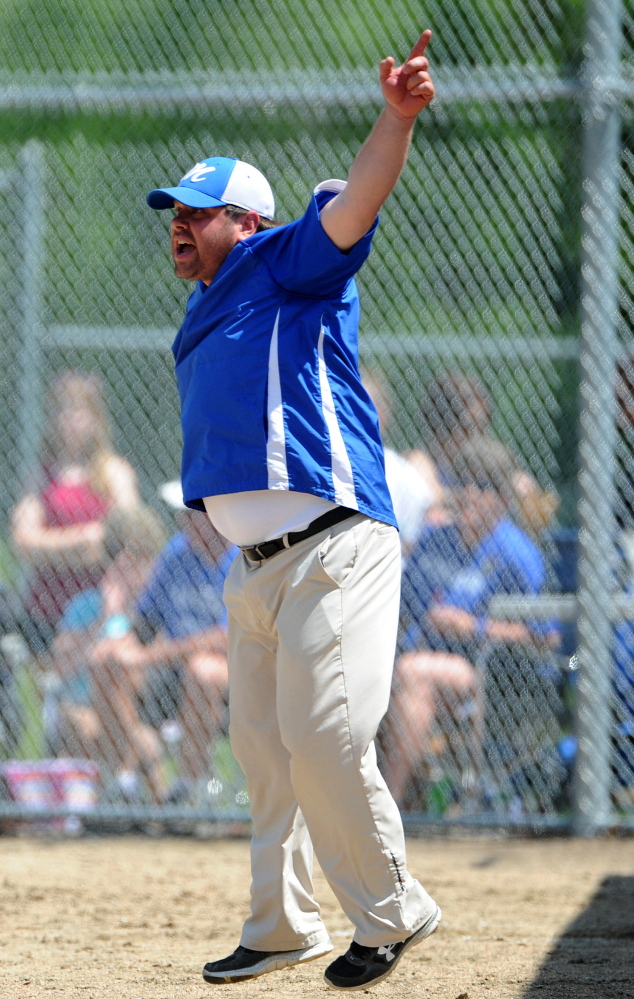 Madison coach Chris LeBlanc waves runners home during a Western C semifinal against Monmnouth in Madison on Saturday.