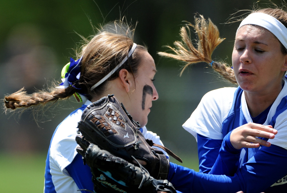 Madison center fielder Sydney LeBlanc, right, collides with right fielder Tori McLaughlin as LeBlanc makes the catch during a Western C semifinal in Madison on Saturday.