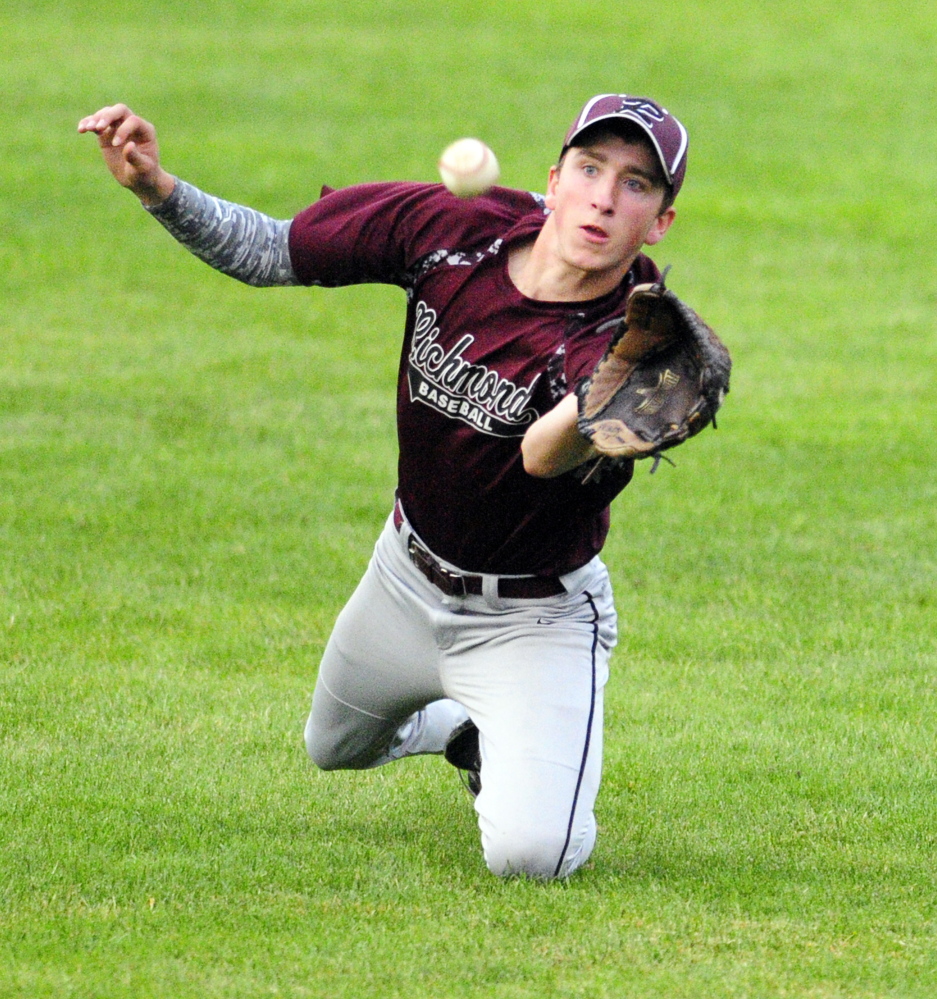 Richmond right fielder Brady Johnson catches a ball to start a double play that he finished by throwing to second base to force out a Searsport baserunner during the Western D title game Tuesday at Larry Mahaney Diamond at St. Joseph’s College in Standish.