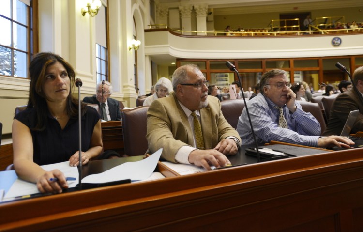 Left to right, Representatives Sara Gideon of Freeport, Mark Dion of Portland and Chuck Kruger of Thomaston cast a vote during a house session to take override votes Thursday, June 18, 2015. (Photo by Shawn Patrick Ouellette/Staff Photographer)