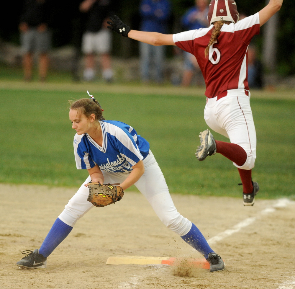 Messalonskee’s Dakota Bragg, left, digs out the ball on a play at first base as Bangor High School’s Lilli Wiseman (6) jumps over her leg to tag first in the Eastern A final Wednesday at Cony High School in Augusta. Bragg is hitting about .380 to lead a versatile and potent Eagles lineup.