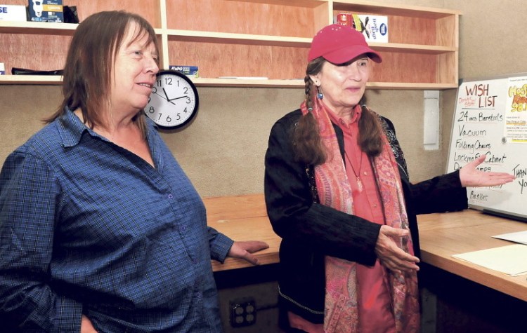 Lolly Phoenix, left, and WXNZ-LP 98.1 radio station manager Annie Stillwater Gray discuss further fundraising Tuesday as they work to make the station operational in the former Somerset County Jail in Skowhegan.
