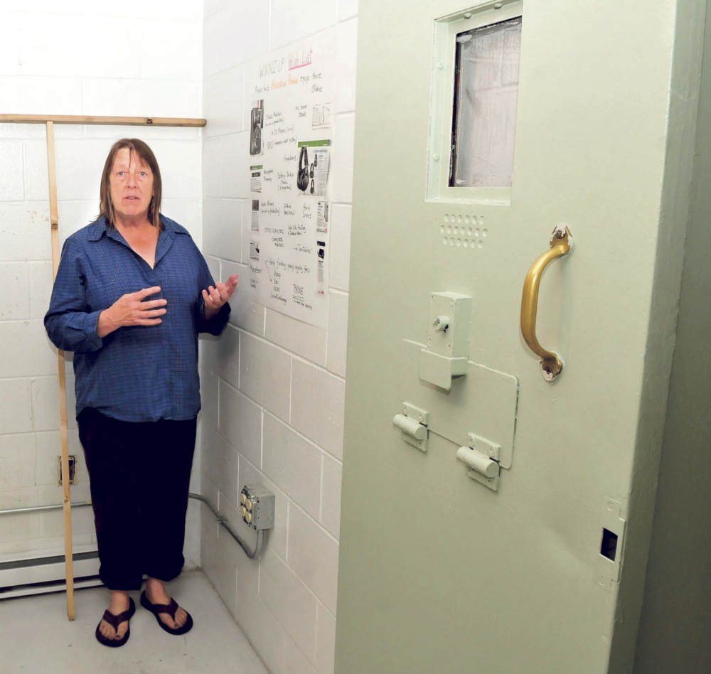 Lolly Phoenix speaks about radio station needs Tuesday inside the WXNZ-LP studio in the former Somerset County Jail in Skowhegan. At right is a sliding reinforced jail door in a cellblock.