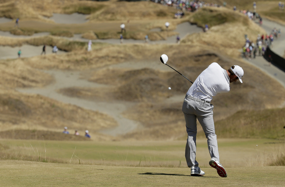 Dustin Johnson hits his tee shot on the fourth hole during the final round of the U.S. Open golf tournament at Chambers Bay on Sunday, June 21, 2015 in University Place, Wash.