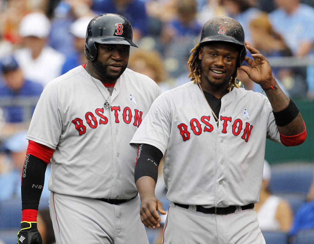 Boston Red Sox’s David Ortiz, left, and Hanley Ramirez, right, head to the dugout after scoring on a Xander Bogaerts double in the fifth inning Sunday against the Kansas City Royals. The Red Sox won 13-2.