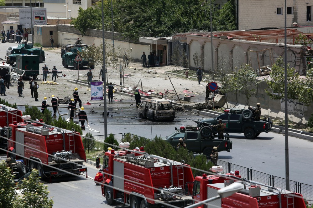 Afghan security forces and first responders  gather at the site of a complex attack by Taliban fighters in front of the Parliament, in Kabul, Afghanistan, Monday.