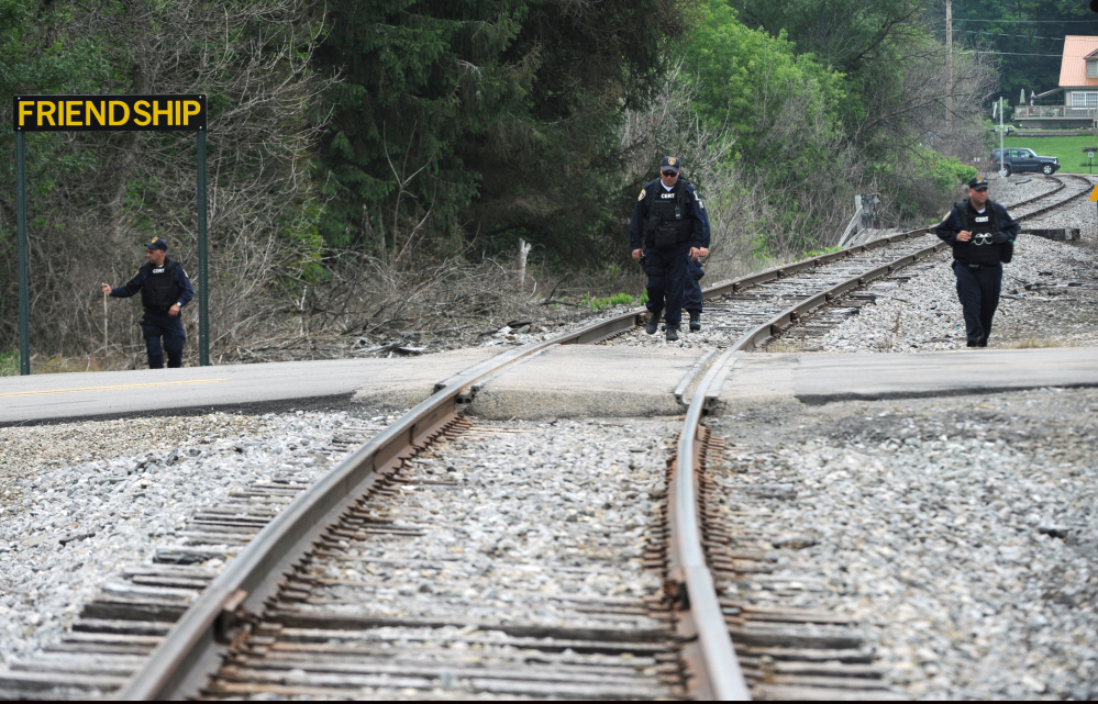 New York State Department of Corrections officers search the railroad tracks after a possible sighting of the two murder convicts who escaped from a northern New York prison two weeks ago in Friendship, N.Y.