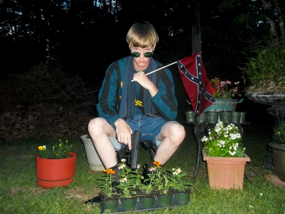 This undated image that appeared on Lastrhodesian.com, a website being investigated by the FBI in connection with Charleston, S.C., shooting suspect Dylann Roof, shows Roof posing for a photo while holding a Confederate flag.