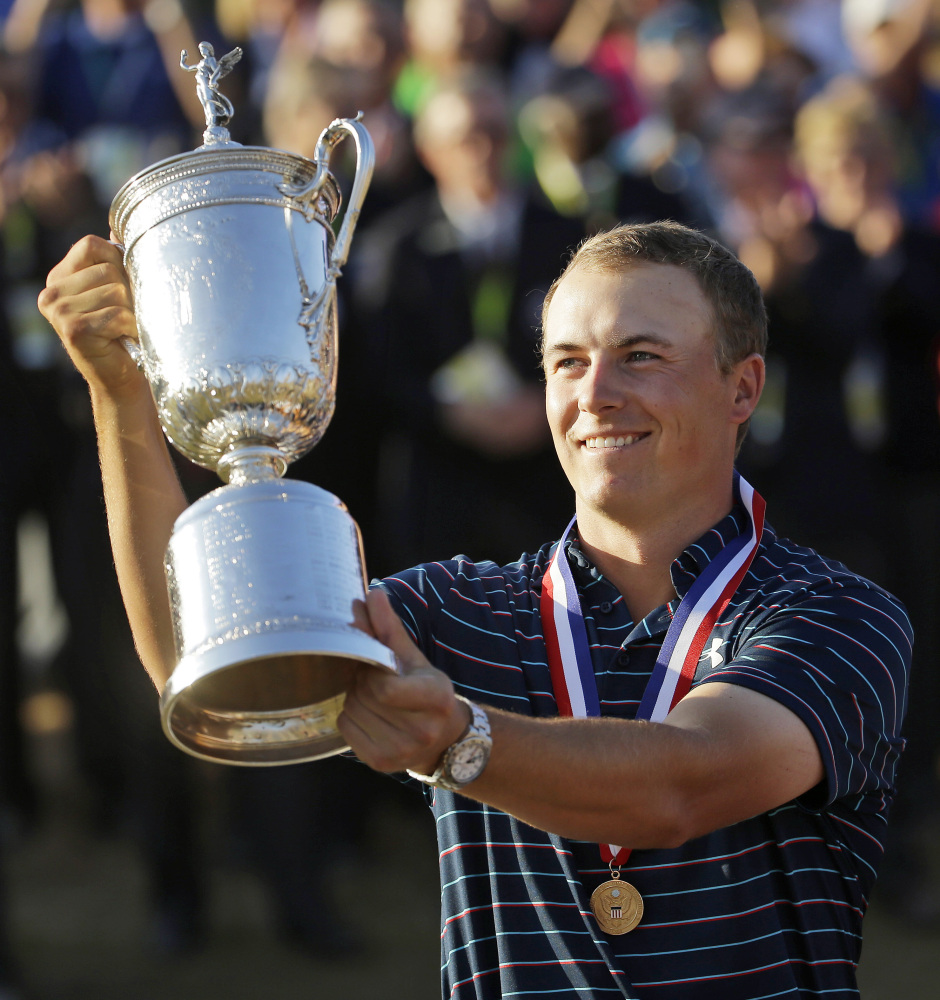 AP photo 
 In this Sunday photo, Jordan Spieth holds up the trophy after winning the U.S. Open at Chambers Bay in University Place, Wash. Spieth loves golf history, which is appropriate for someone quickly becoming part of it.