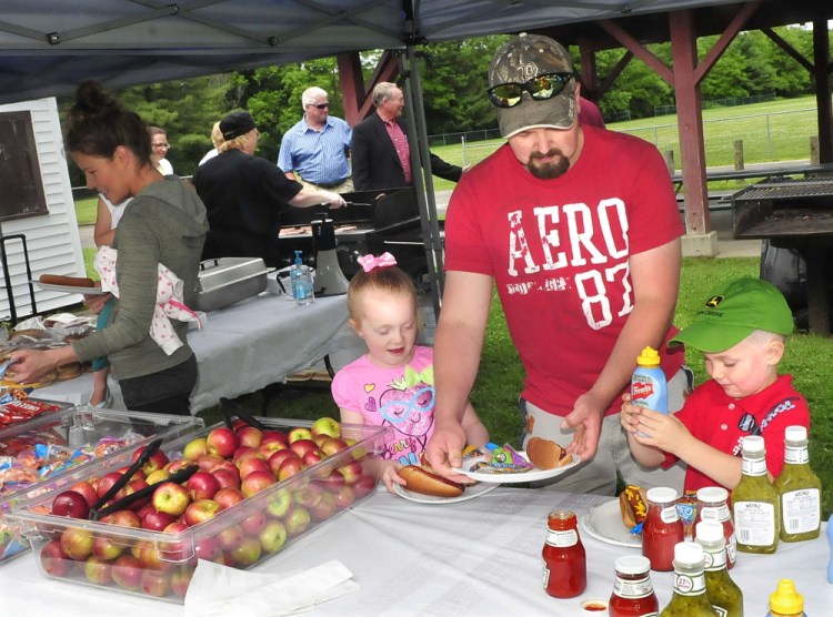Steven Proctor and his kids Desirae and Dylan take part in a free lunch on Monday during the kickoff of the food summer program sponsored by AOS 92 and the USDA that serves children under 18 in Waterville, Winslow and Vassalboro.