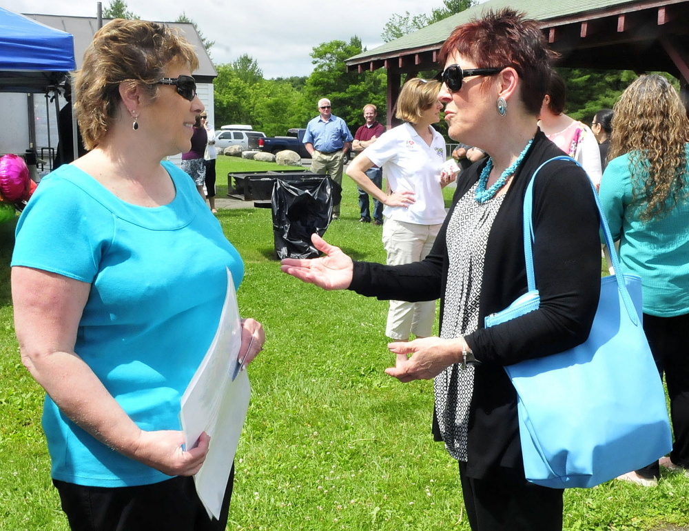 AOS 92 Food Service Director Paula Pooler, left, and Jan Kallio of the USDA, discuss the summer food program during a kickoff of the program in Waterville on Monday.