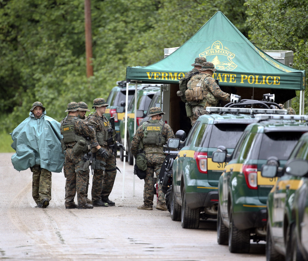 Law enforcement officers gather as the search continues for two prison escapees from Clinton Correctional Facility in Dannemora, on Tuesday, in Malone, N.Y.
