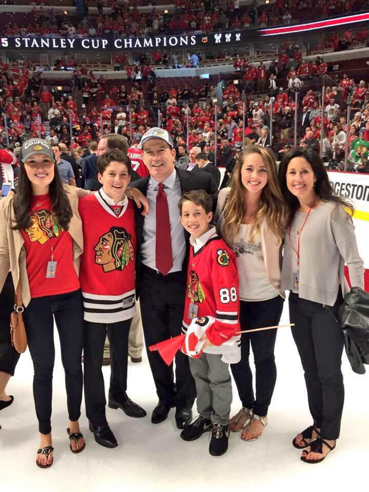 Former Portland Pirates coach Kevin Dineen and his family, from left, Hannah, William, Kevin, Declan, Emma and Annie, celebrate the Blackhawks clinching victory on the United Center ice earlier this month.