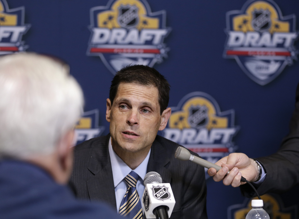 Boston Bruins general manager Don Sweeney talks with members of the media Friday before the start of the 2015 NHL draft in Sunrise, Fla. The Bruins traded away Milan Lucic to Vancouver and Dougie Hamilton to Calgary.