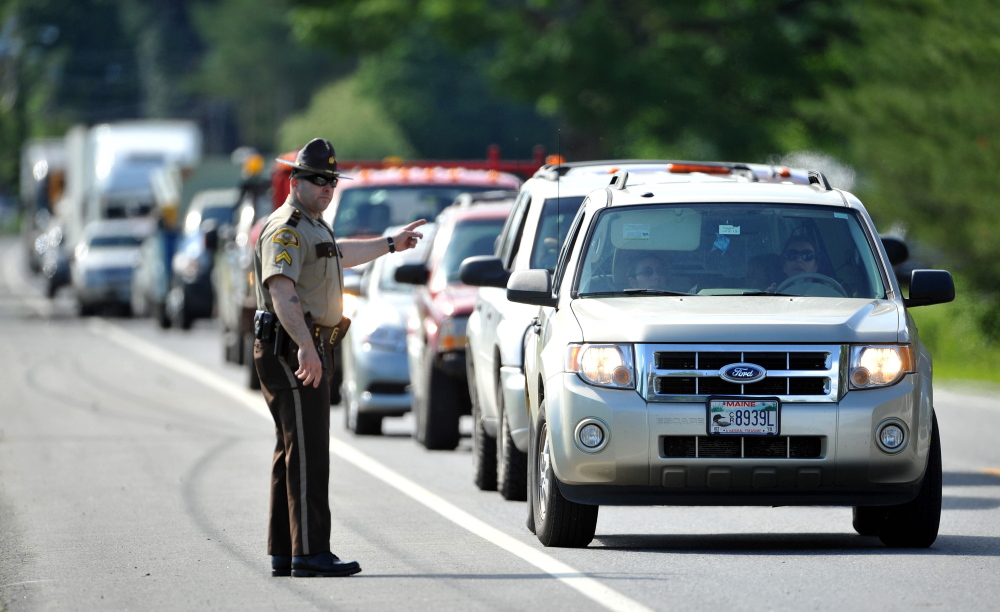 Traffic backs up Friday on Route 139 in Norridgwock at the scene of a three-vehicle collision that injured two drivers.