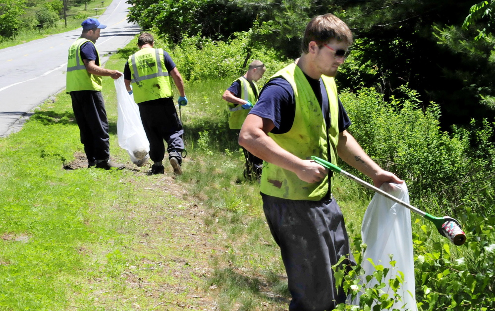 Somerset County Jail inmates take part in a community service project Wednesday by picking up litter along U.S. Route 201A in Norridgewock. From left are Jason Oliver, Richard Austin, Andrew Vesey and Brett Ward.