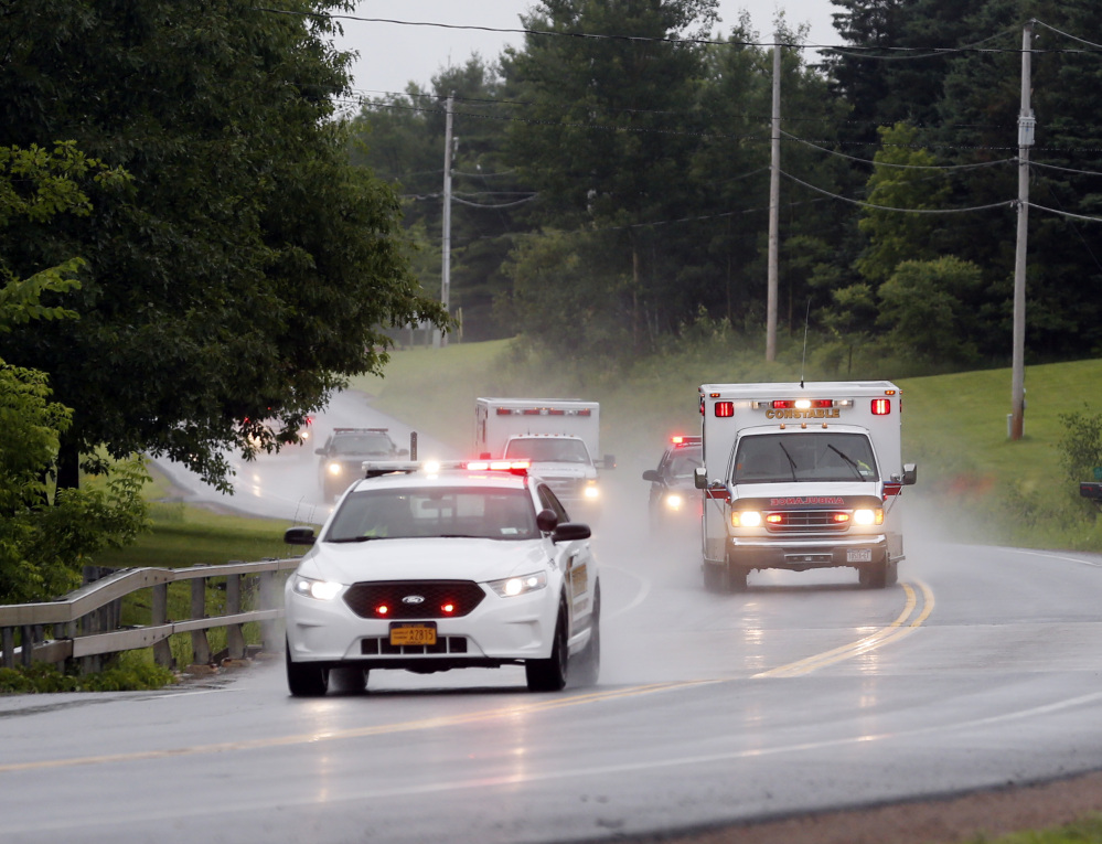 Police escort ambulances from an area where law enforcement officers were searching for convicted murderer David Sweat, one of two convicted murderers who broke out of a maximum-security prison near the Canadian border in Constable, N.Y.