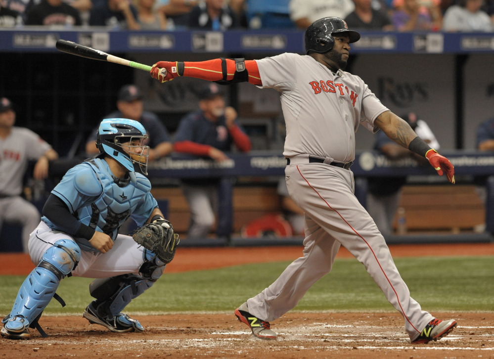 Tampa Bay Rays catcher Rene Rivera, left, looks on as Boston Red Sox designated hitter David Ortiz hits a two-run home run to right during the fourth inning Sunday in St. Petersburg, Fla. The Red Sox won 5-3.
