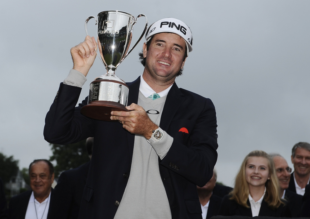 Bubba Watson holds with the championship trophy Sunday after winning the Travelers Championship in Cromwell, Conn.  Watson beat out Paul Casey in a playoff.
