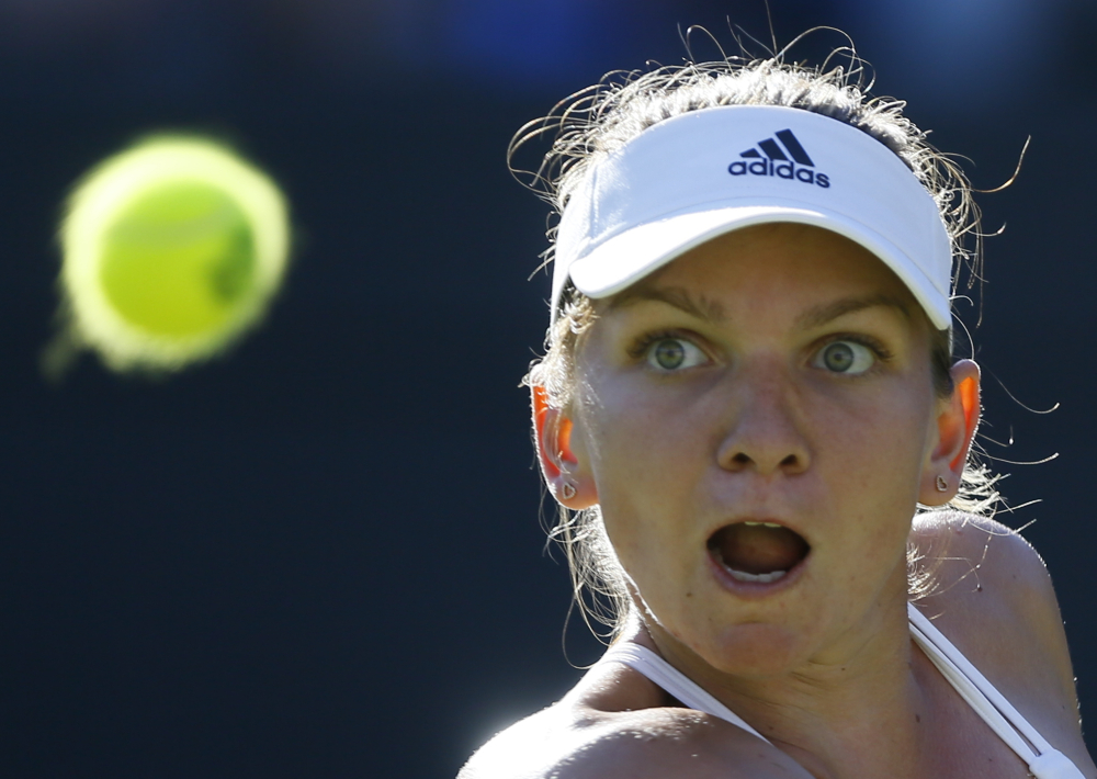 AP photo 
 Simona Halep watches the ball during the singles first round match against Jana Cepelova on Tuesday at the All England Lawn Tennis Championships in Wimbledon, London.