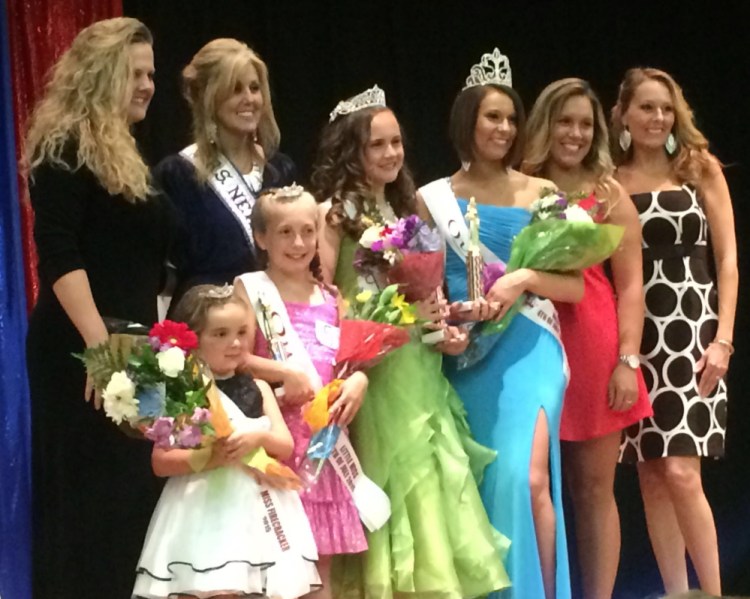The winners of the Winslow Miss 4th of July pageant on stage Saturday, including Miss 4th of July Molly Lybrook, wearing the blue dress. It was later found that votes were tallied incorrectly and Lybrook didn’t win. Organizers want Lybrook and the new winner, Caitlin Grenier, to share the crown, but Lybrook doesn’t want to.