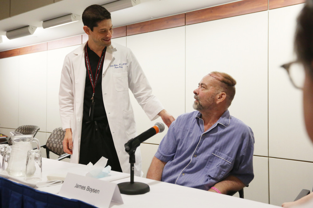 Jim Boysen, right, received a partial skull and scalp transplant to treat a large head wound that he had developed as a result of cancer treatment. “I’m still ... in awe of it,” he said.