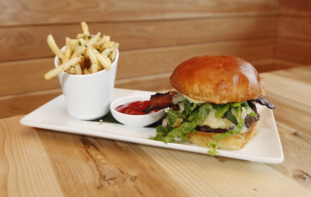 The Rudy’s Burger is topped with bacon, cheddar, caramelized onion, shredded lettuce and horseradish aioli.