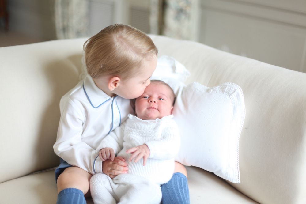 This image made available by Kensington Palace Saturday, June 6, 2015, taken by Kate, Duchess of Cambridge, at Amner Hall, eastern England in mid-May 2015 shows Britain’s Princess Charlotte, right, being held by her brother, 2-year-old, Prince George. Duchess of Cambridge/ The Associated Press