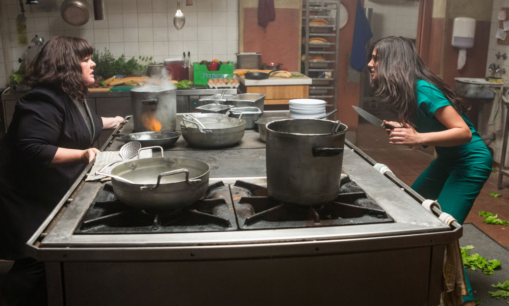 Melissa McCarthy, left, faces off against a knife-wielding adversary, Nargis Fakhri, in a scene from “Spy.”