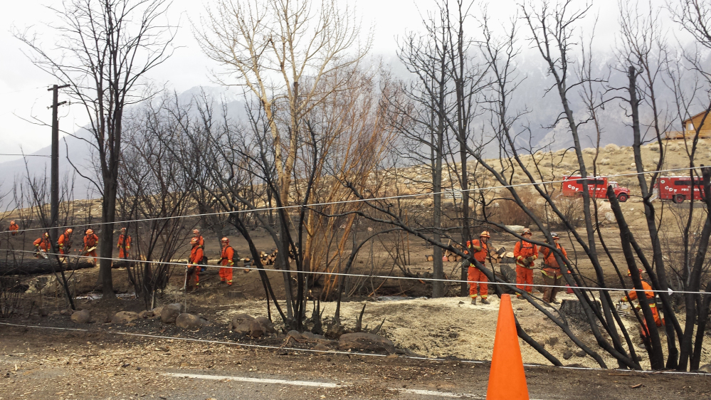 Crews of inmate workers clear charred trees along the road near Swall Meadows, Calif., after a wildfire destroyed 40 homes and buildings. Republican lawmakers say more aggressive timbering would make for a healthier forest and improve rural economies.
