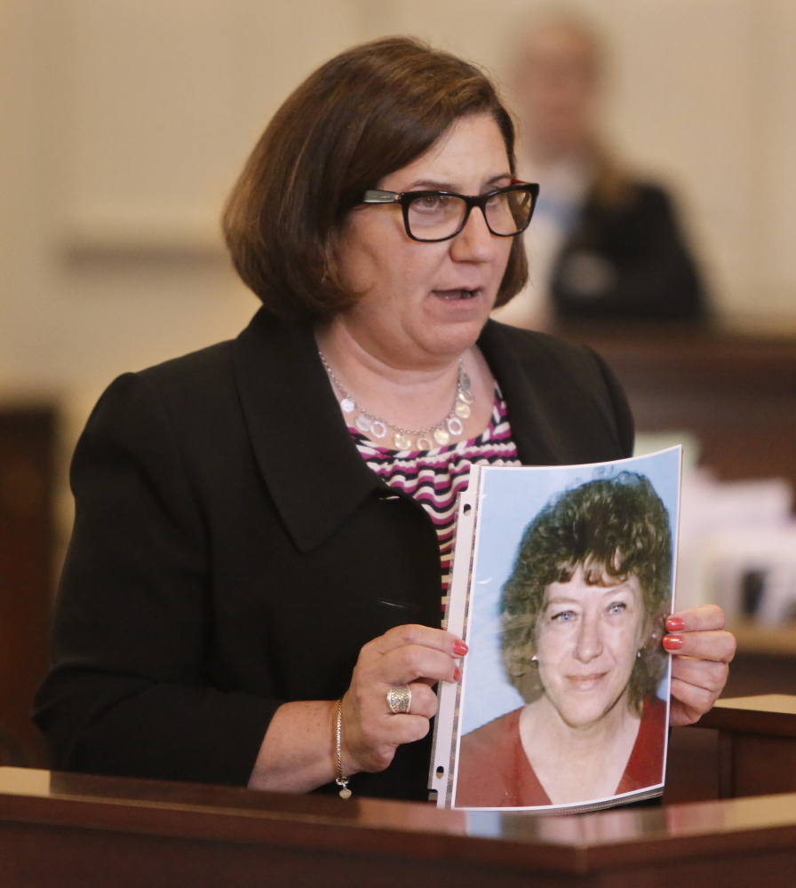 Assistant Attorney General Leane Zainea holds a photo of Patricia Noel, the victim, during opening statements in the murder trial of Derek Poulin at York County Superior Court in Alfred on Thursday.