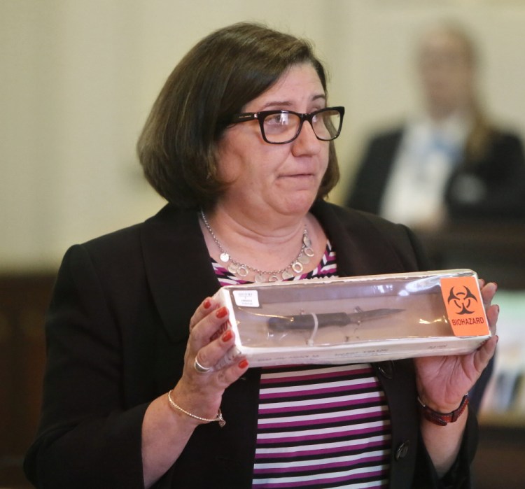Assistant Attorney General Leane Zainea shows members of the jury a knife she says was used to stab Patricia Noel more than 70 times when she was killed in her Old Orchard Beach home in 2012.