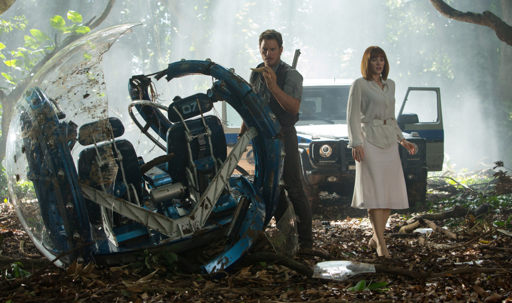 Chris Pratt, left, and Bryce Dallas Howard star in a scene from “Jurassic World,” directed by Colin Trevorrow.