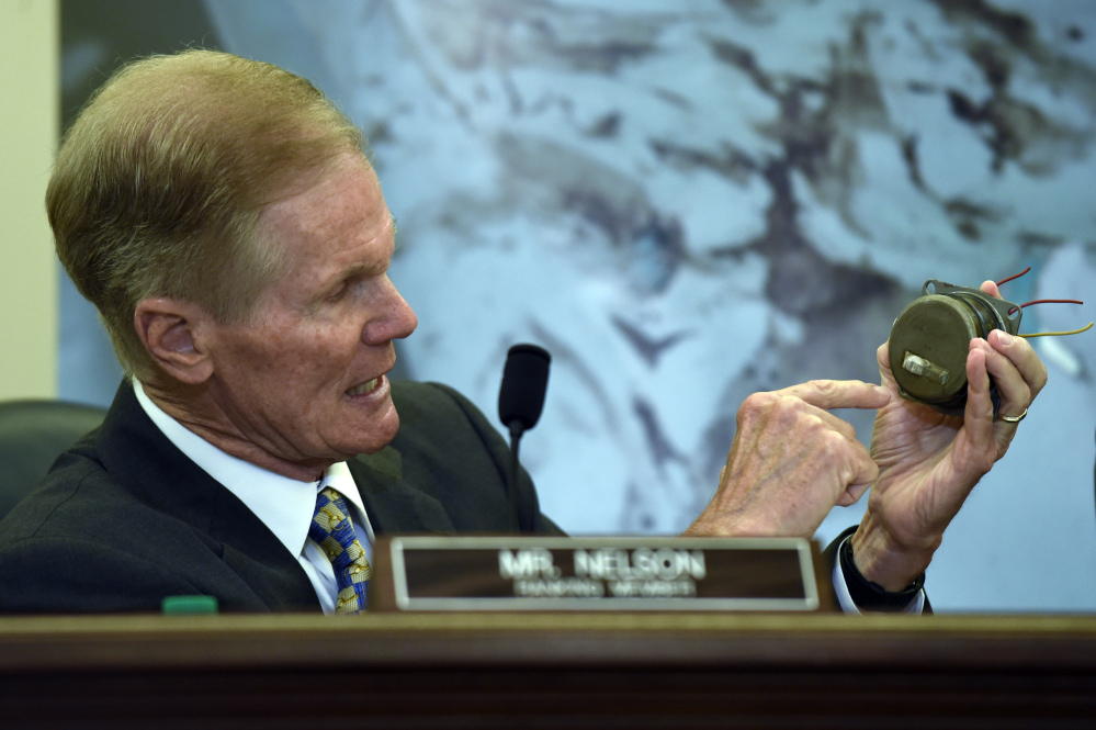 Sen. Bill Nelson, D-Fla., holds a Takata Corp. air bag inflator during a Senate Commerce, Science, and Transportation Committee hearing on Capitol Hill on Tuesday,