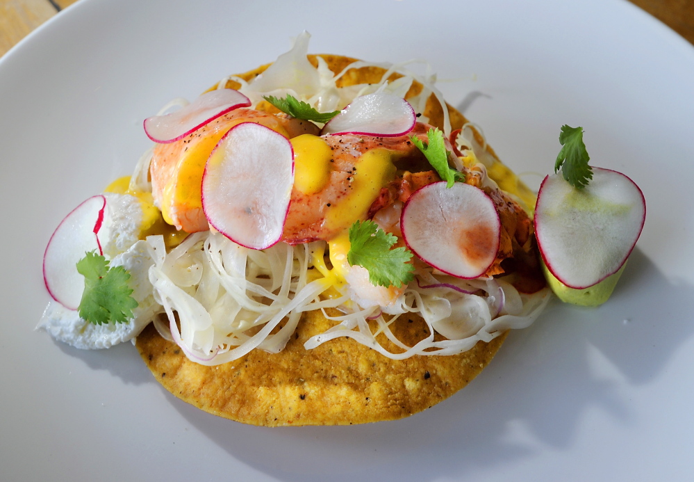 Lobster tostada with aji amarillo vinaigrette, avocado and lime crema.