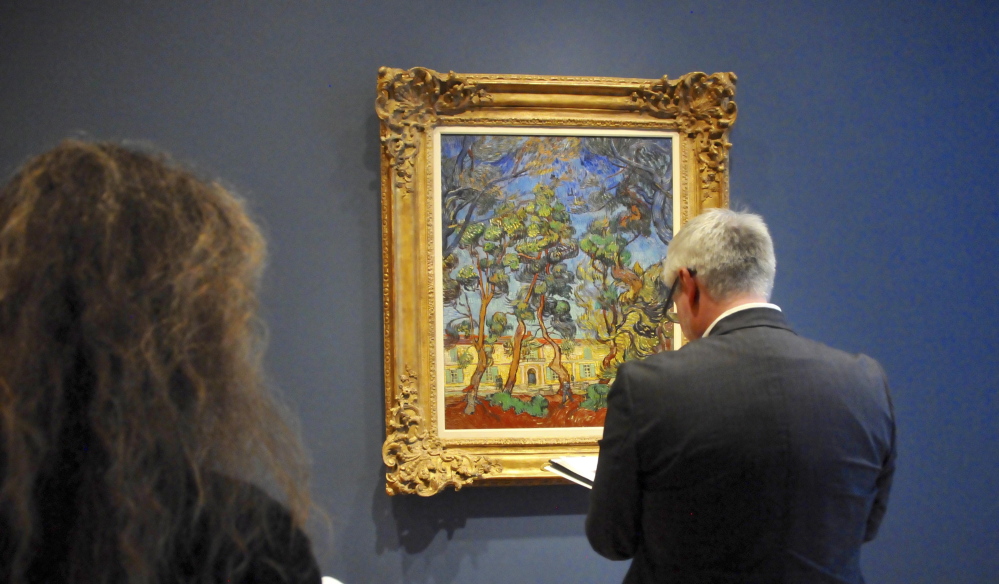 People observe Van Gogh’s “Hospital at Saint-Remy” at the Clark Art Institute in Williamstown, Mass. The exhibit, which runs through Sept. 13, features more than 40 artworks by Vincent Van Gogh.