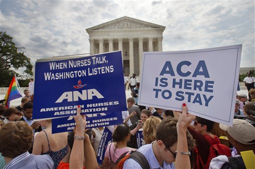 Supporters of the Affordable Care Act hold up signs as the opinion for health care is reported outside of the Supreme Court in Washington, Thursday June 25, 2015. The Supreme Court on Thursday upheld the nationwide tax subsidies under President Barack Obama's health care overhaul, in a ruling that preserves health insurance for millions of Americans. The justices said in a 6-3 ruling that the subsidies that 8.7 million people currently receive to make insurance affordable do not depend on where they live, under the 2010 health care law.  (AP Photo/Jacquelyn Martin)