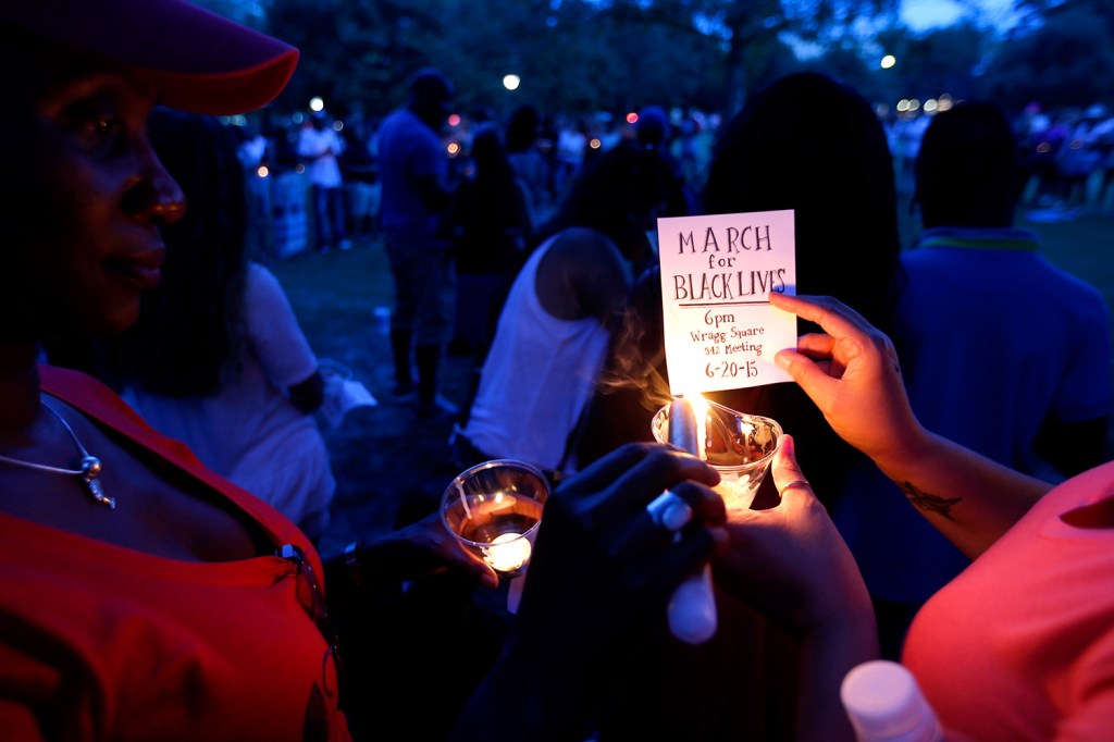 Mourners gather at Marion Square for a candlelight vigil near the Emanuel AME Church in Charleston, S.C. Dylann Storm Roof, 21, was arrested Thursday in the slayings of several people, including the pastor at a prayer meeting inside the historic black church.
