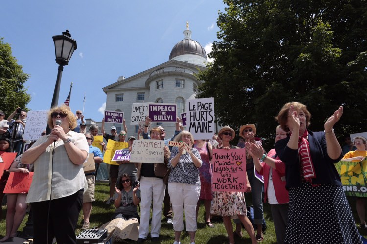 Protesters critical of Gov. Paul LePage gather outside the State House in Augusta on Tuesday.