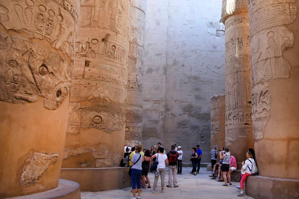 Tourists roam among the hieroglyphic-covered columns in the Hypostyle Hall at the Karnak Temple in Luxor, Egypt, in this 2014 photo. The southern city of Luxoris frequented by millions of foreign and Egyptian tourists every year. The Associated Press