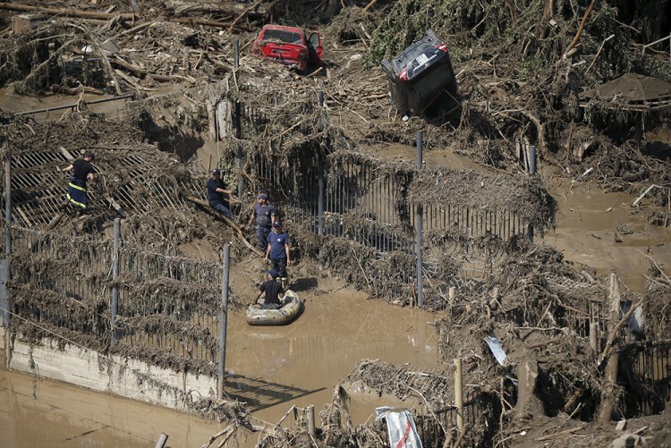 Rescue workers search in debris at the zoo in Tbilisi on Monday after more than 30 animals escaped onto the streets of the Georgian capital on Sunday during floods that killed at least 12 people. Reuters