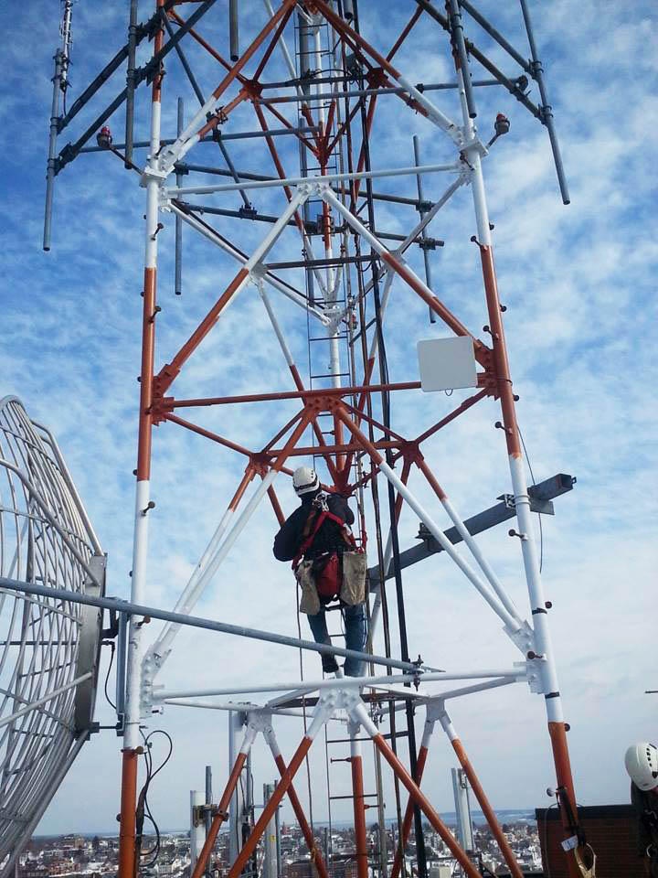 Scott Smith, tower installation foreman at Tilson, climbs a tower used by Redzone Wireless in Portland. Redzone Wireless hopes to provide speedy broadband service to most of Maine by 2017, the company announced Wednesday.